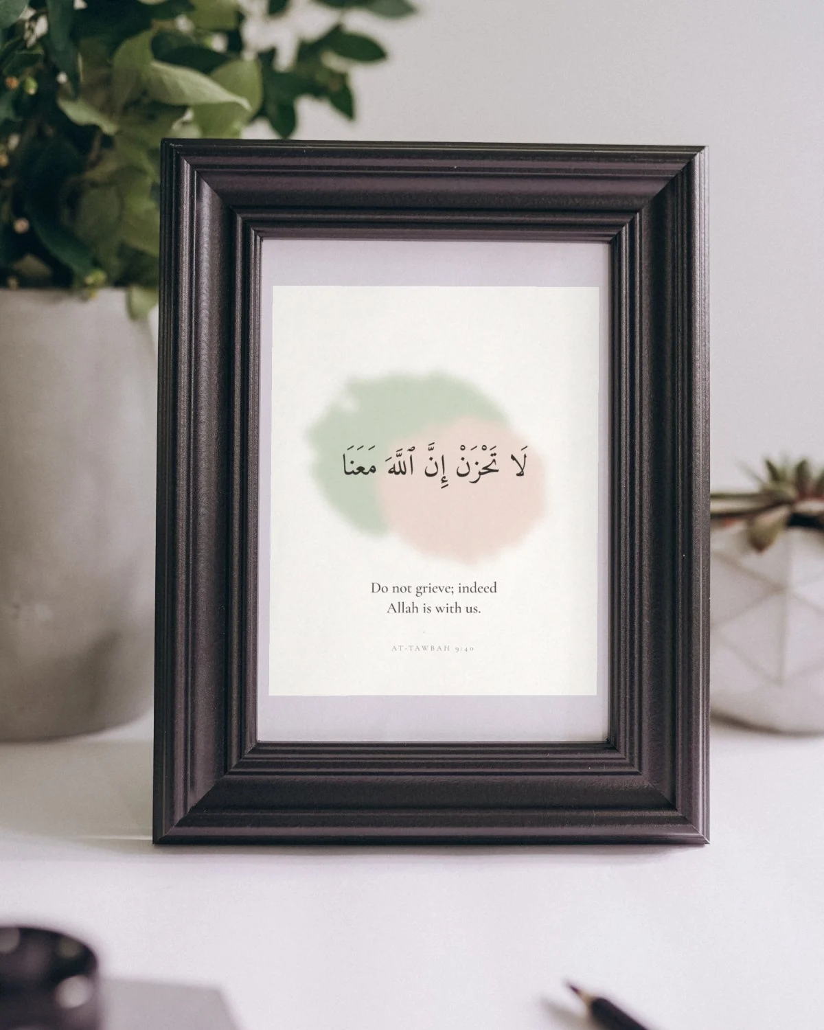 "Do not grieve" Quran verse wall art framed on a shelf