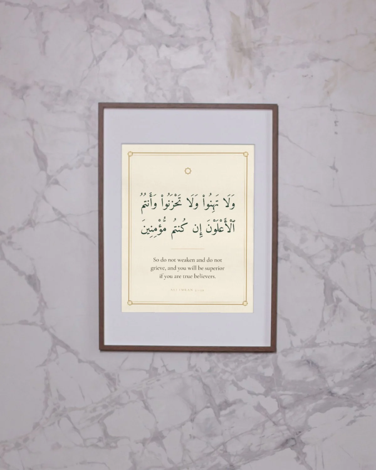 "So do not weaken and do not grieve, and you will be superior if you are true believers" Quran verse wall art framed on a marble wall
