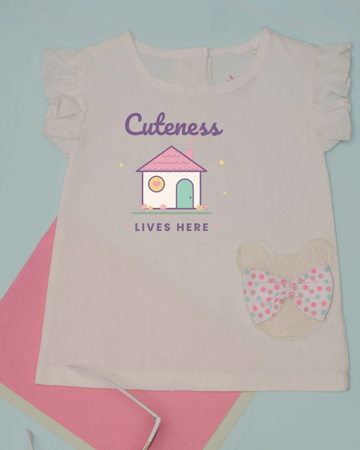 Baby Dress with the "Cuteness lives here." design