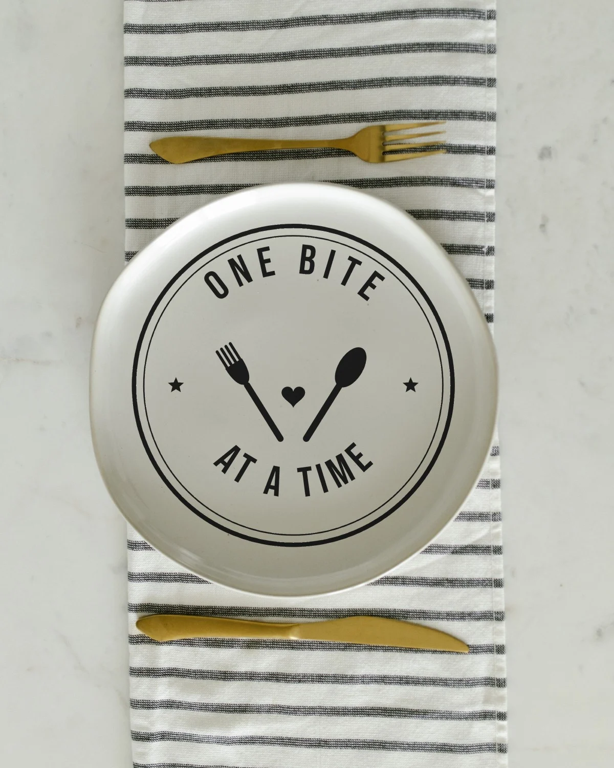 Spoon with the "One bite at a time." design