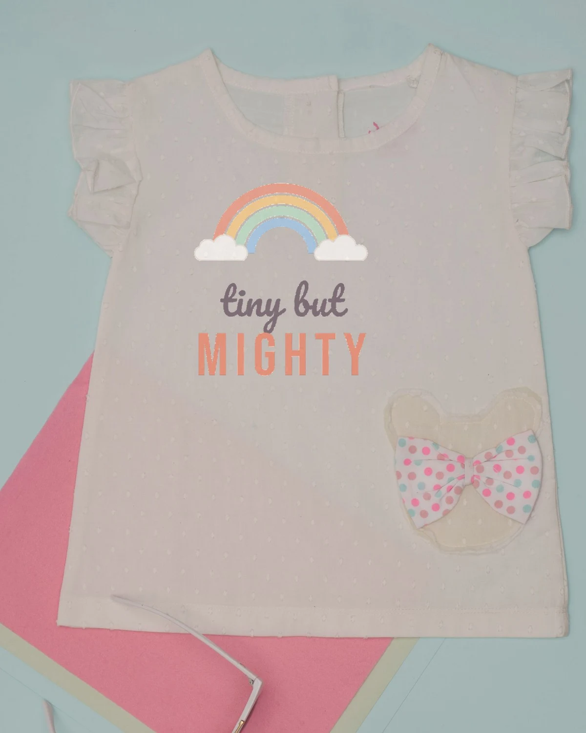 Tiny But Mighty SVG printed on a baby bodysuit