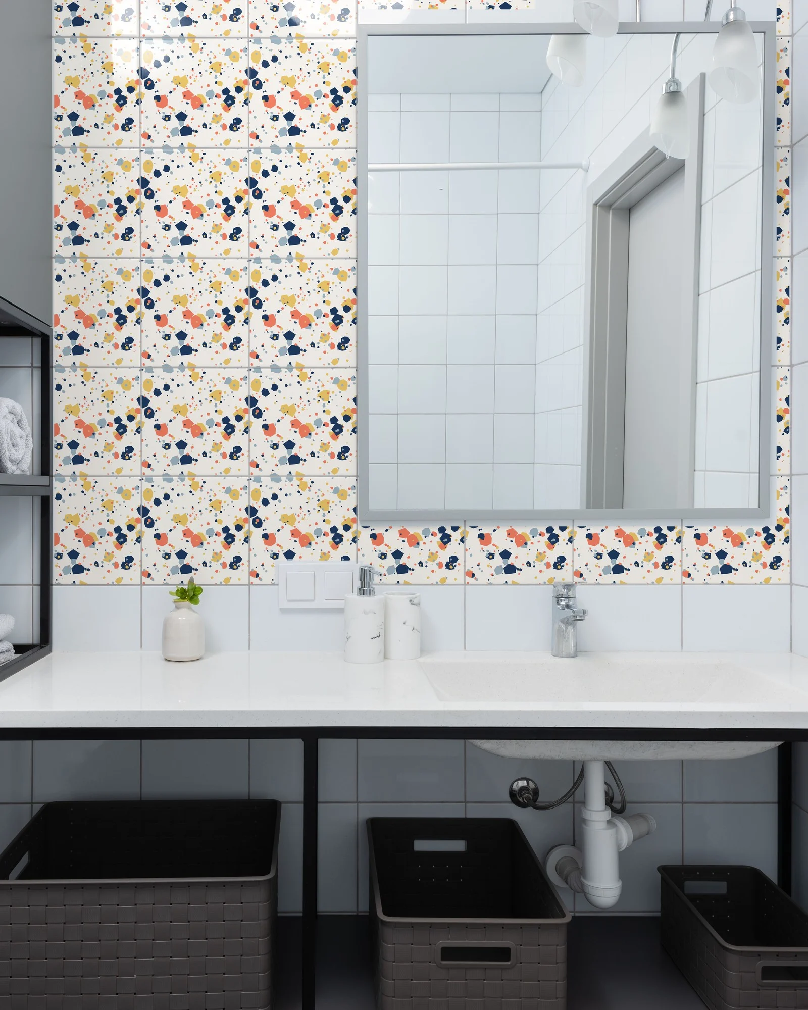 Terrazzo Navy and Coral tiles as a bathroom backsplash above a vanity